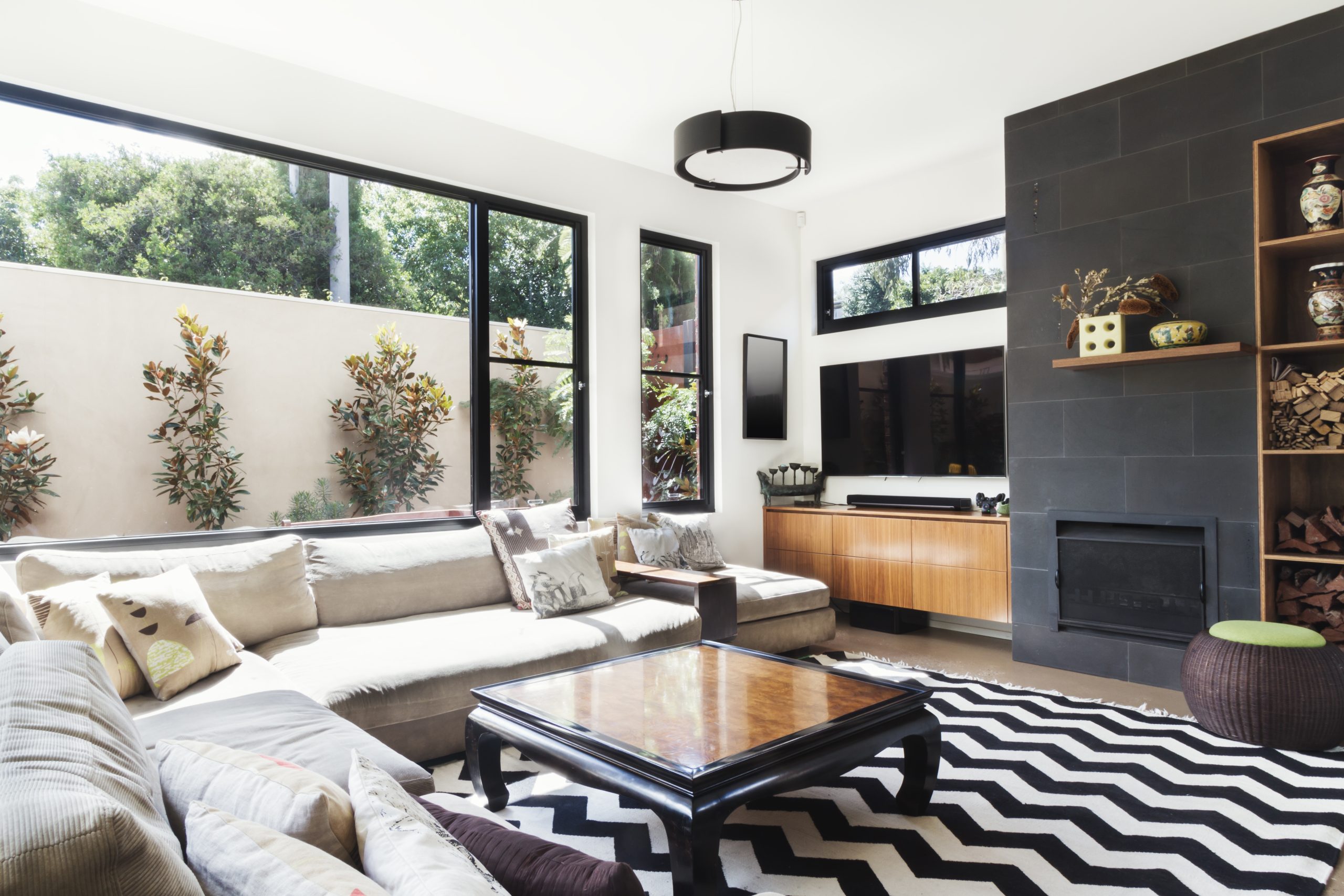 Monochrome Living Room With Aluminum Framing Glass Windows